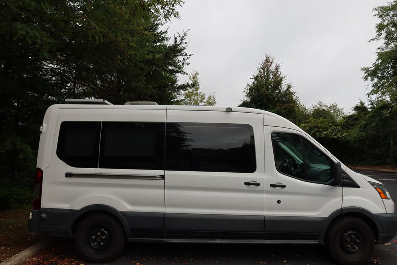  parked outdoors.|Side view of a white camper van — photo 3