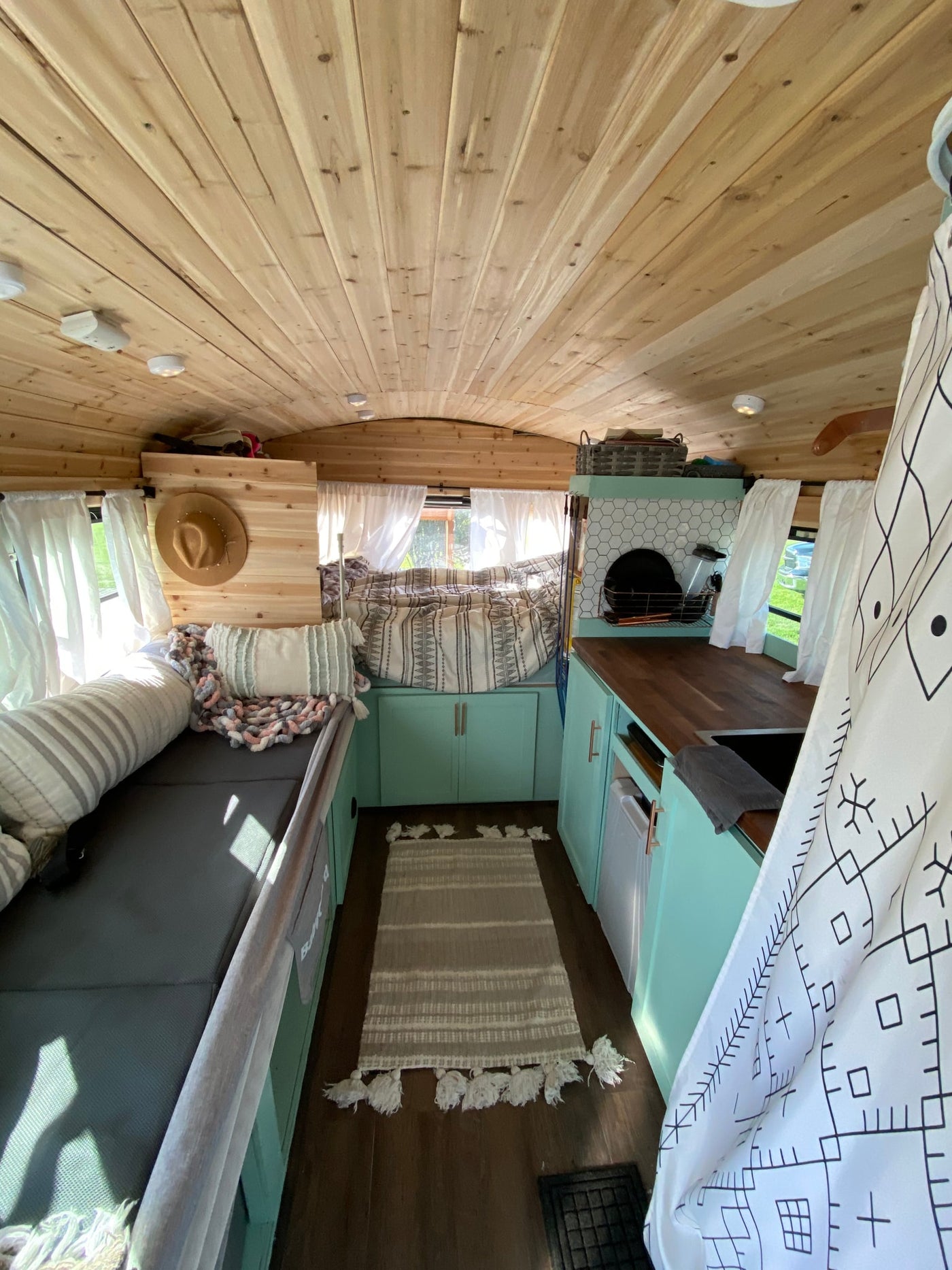  parked among tall pine trees. Perfect for a nature adventure.|Explore this RV rental's cozy — photo 16