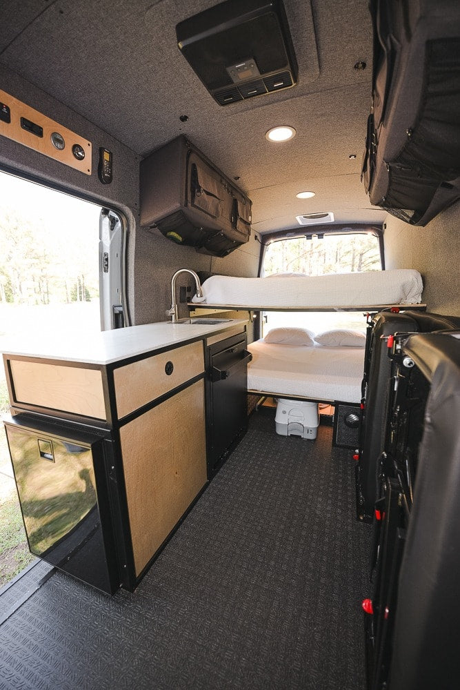  and ample overhead storage for your next adventure.|RV rental: Camper van interior with bunk beds — photo 8