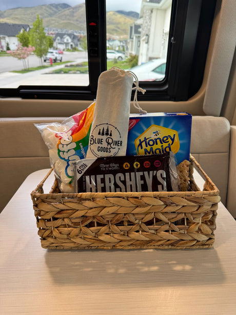 An RV rental welcome: s'mores kit (marshmallows, Hershey's, Honey Maid, Blue River Goods) in a basket, ready for fun.