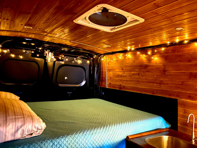  with marina and boats outside.|Explore our cozy RV rental! Features a comfy bed — photo 2