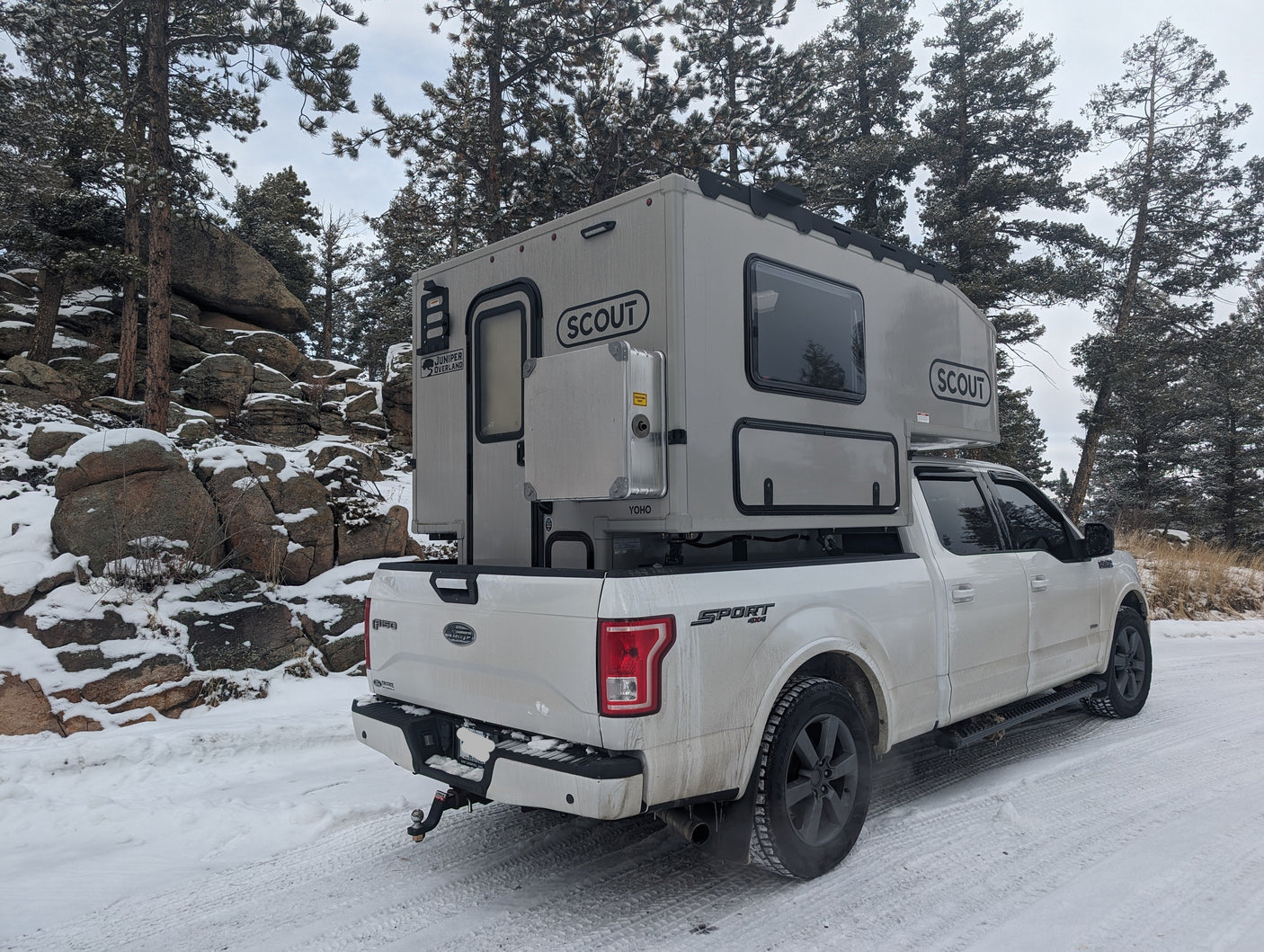 Winter wonderland ready: Ford F-150 with a Scout Yoho truck camper on a snowy road. Perfect for your next rv rental.