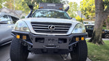 Front view of a white, modified Lexus GX with an iKamper rooftop tent & winch. An ideal off-road rv rental for adventure trips.