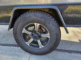 Close-up of a rugged tire and wheel on an rv rental trailer, featuring Goodyear Radial tire and diamond plate fender.