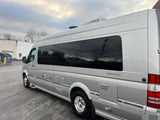Silver Airstream Interstate RV rental, side view. This sleek Class B motorhome has tinted windows and utility ports.