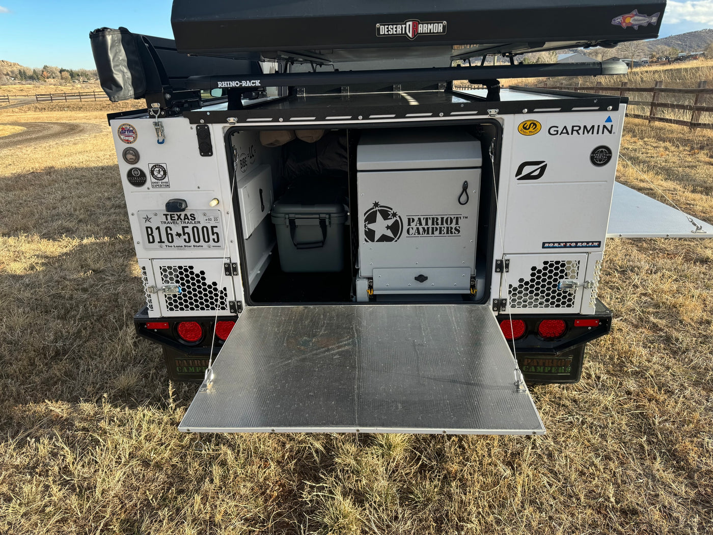 Rear view of an overland trailer, tailgate open with fridge & storage. Great RV rental for adventure! — photo 11