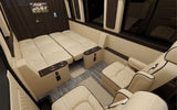 Explore a spacious luxury RV rental interior: cream leather seats, convertible bed, captain's chairs for premium travel.
