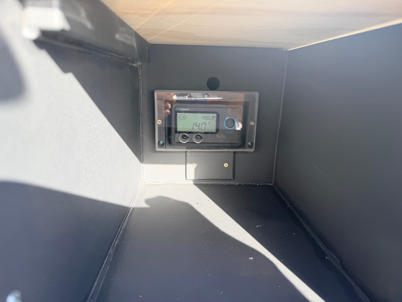 Monitor your RV rental's power with this Renogy battery display. It shows 14.0V, crucial for your off-grid adventures.