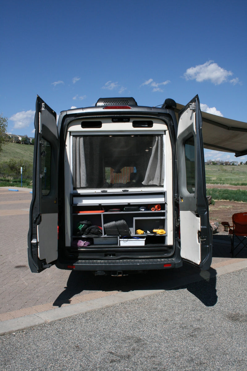 Rear view of an RV rental camper van, doors open to reveal custom organized storage. Ready for your next outdoor adventure. — photo 5