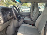 Interior of a Ford van, ideal for rv rental, showing driver's and passenger seats, steering wheel, and dashboard.
