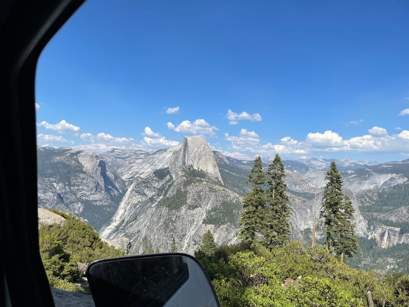 Yosemite's Half Dome from an RV rental! Majestic mountains, lush forests, and distant waterfalls under a clear blue sky. — photo 16