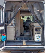 This RV rental offers a modular interior with comfortable cushions, versatile storage, and a convenient water utility panel visible.