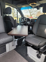 RV rental: Swivel front seats & a mounted table create a compact dinette with bench seating.