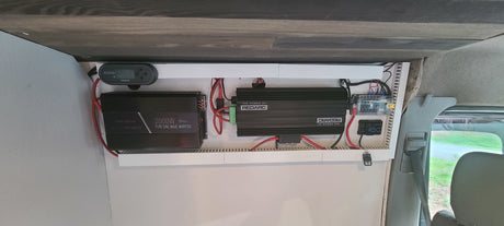 RV rental van's power system: Redarc manager, 2000W inverter, fuse box, and wiring for robust off-grid use.