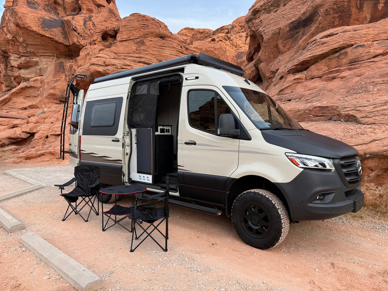  revealing a welcoming outdoor setup.|Stunning desert sunset with an RV rental: a grey and black Winnebago Revel camper van on a dirt road — photo 23