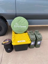 Prepping an RV rental with camping gear: a Wolfwise pop-up tent, Ignik propane, Scepter water jugs, and a shower storage bin.