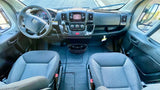 Spacious RV rental cabin interior: driver/passenger seats, dashboard, and steering wheel visible for your road trip comfort.