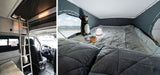 Comfortable RV rental with a cozy pop-top sleeping area, ladder access, and scenic lake views for your next adventure.