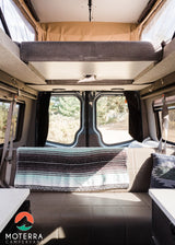 Spacious RV rental interior with a cozy pop-top bed & scenic views for your next adventure. Ready for travel!