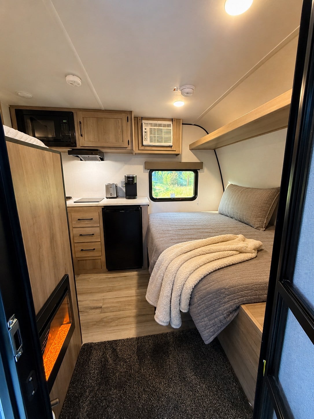  surrounded by pine trees and snow-capped peaks. Perfect for nature camping.|RV rental floor plan: Cozy layout with bed — photo 7
