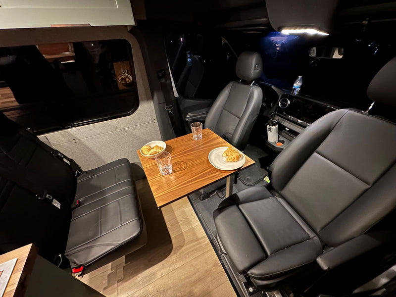  perfect for a relaxing travel meal.|Silver RV rental van parked by the water — photo 5