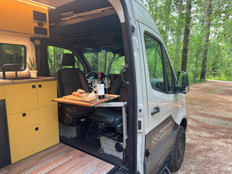 Cozy camper van interior with kitchen and dining, perfect for an RV rental adventure in nature.