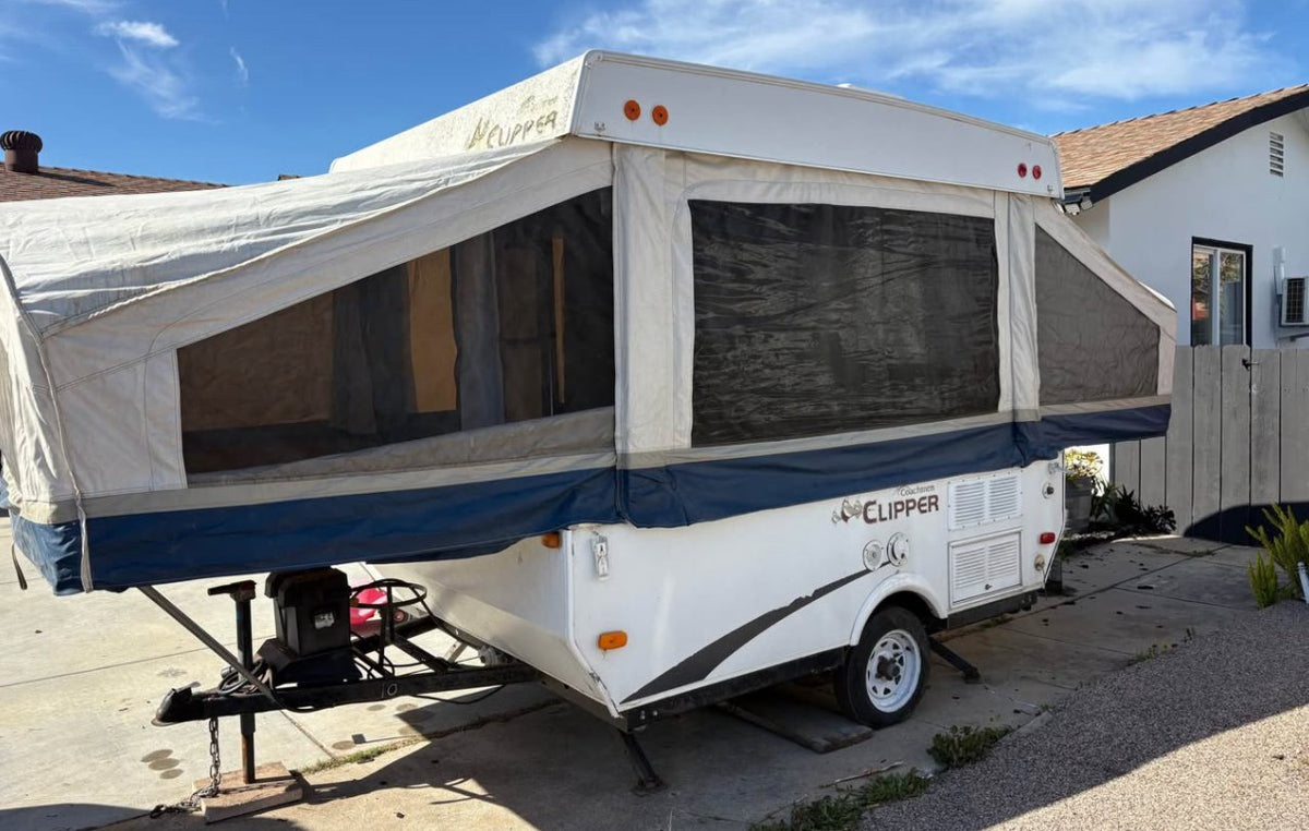  and storage areas.|Gray Ford Bronco Sport SUV towing a white Coachmen Clipper pop-up camper — photo 3
