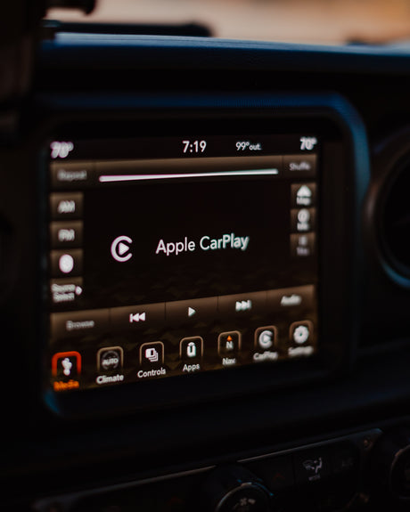 Vehicle infotainment screen in an RV rental setup shows Apple CarPlay, 7:19 time, 99°out, 70° cabin temp, and nav.