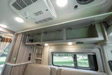 RV rental camper van interior showing open overhead storage, ceiling AC, cozy seating, and a window with outdoor views.