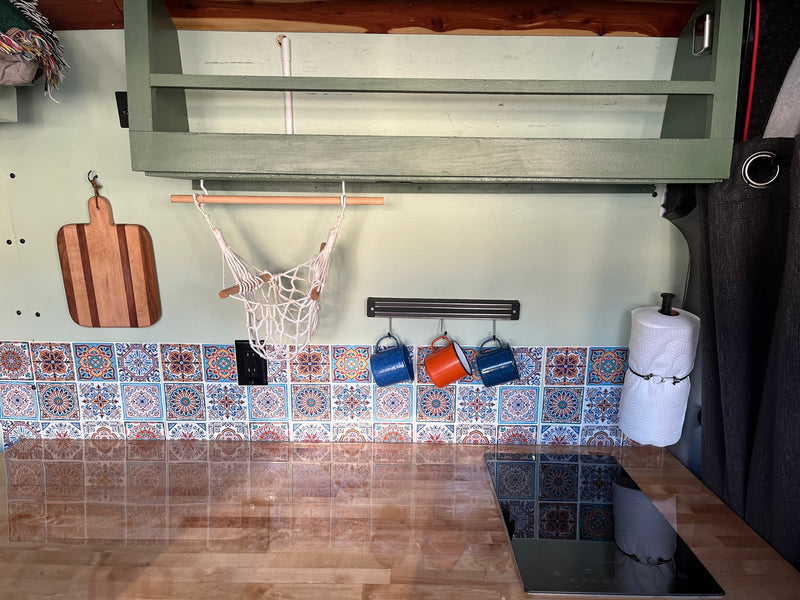  and front seats with patterned covers. Sunshade on windshield.|RV rental kitchen: Wood counter — photo 11