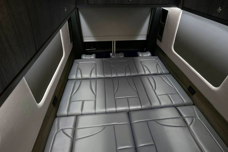  and picturesque mountain views.|Luxury RV rental interior: gray convertible bed — photo 3