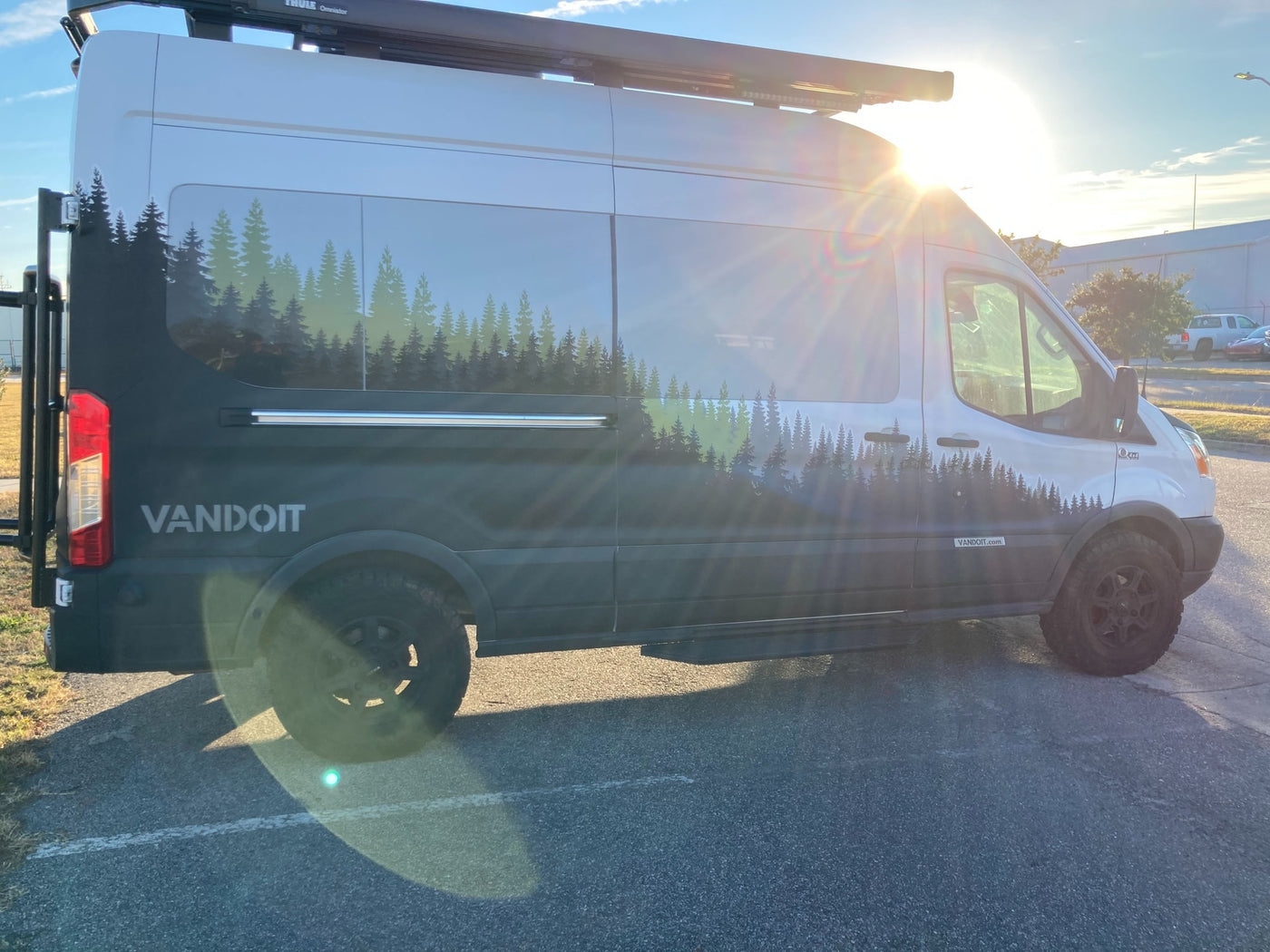 A sunlit Vandoit camper van, featuring a striking forest graphic, makes for an ideal RV rental. Ready for adventure! — photo 7
