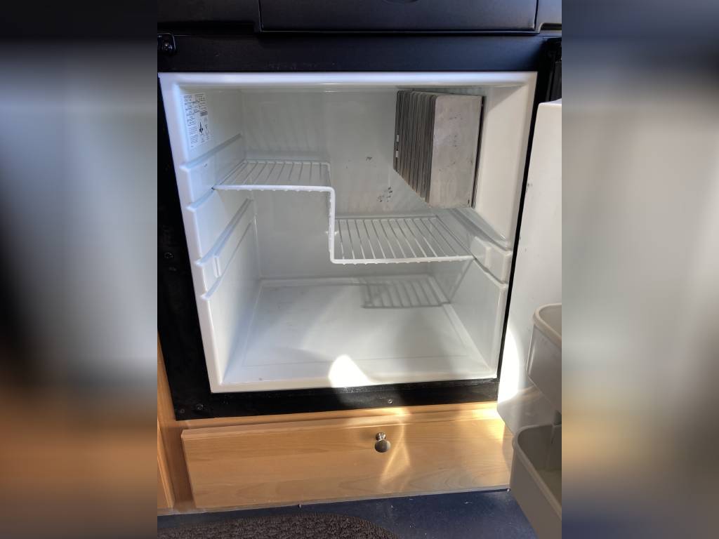 Empty mini-fridge in an RV rental, ready for your road trip snacks and drinks. — photo 7