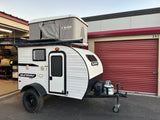 Explore with this white Sunray Sport teardrop camper, featuring a Maggiolina rooftop tent – perfect for an RV rental adventure!