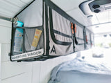 Stay organized in your RV rental: an "Adventure Wagon" overhead storage unit keeps toiletries and essentials tidy in this camper van.