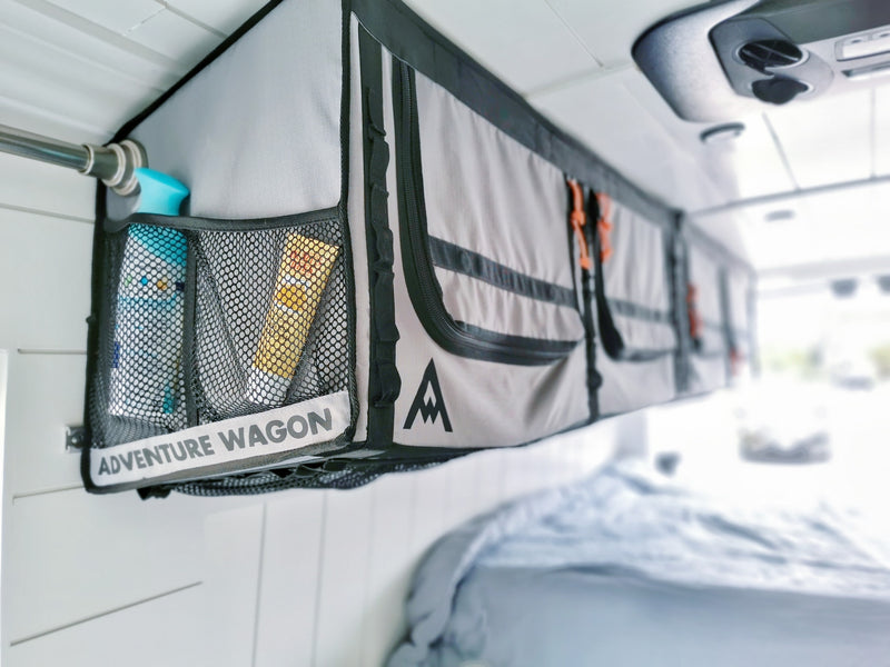 Stay organized in your RV rental: an "Adventure Wagon" overhead storage unit keeps toiletries and essentials tidy in this camper van. — photo 12