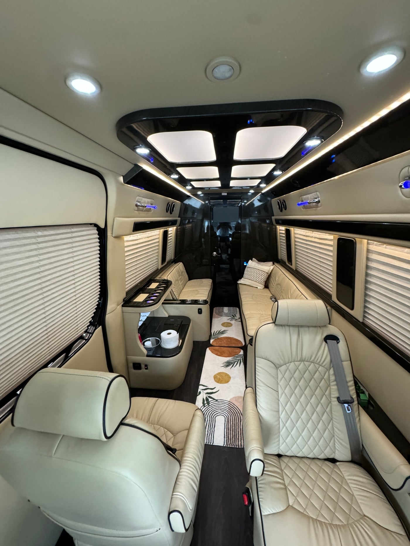 Step into luxury with this custom van interior, featuring plush seating and ambient lighting, ideal for your next rv rental trip. — photo 7