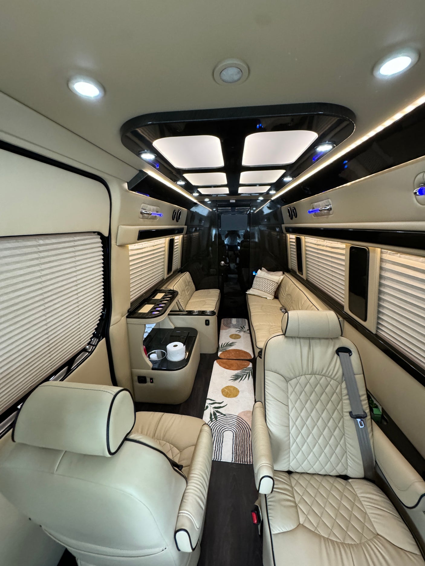 Step into luxury with this custom van interior, featuring plush seating and ambient lighting, ideal for your next rv rental trip.