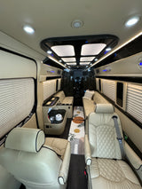 Step into luxury with this custom van interior, featuring plush seating and ambient lighting, ideal for your next rv rental trip.