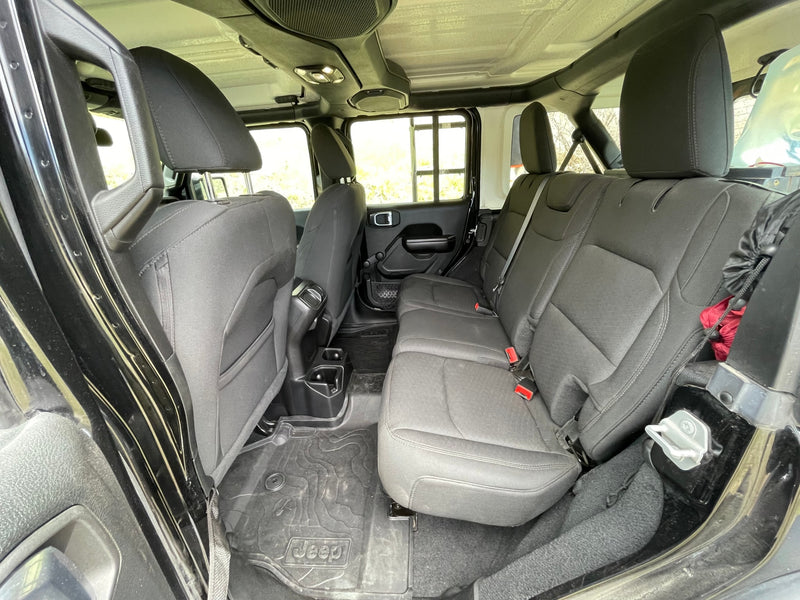 Spacious rear interior of a Jeep Wrangler, with black seats & all-weather floor mats. Ideal for an adventure rv rental. — photo 13