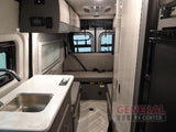 Spacious RV rental interior featuring a kitchen, bench seating, and compact living area for comfortable travel.