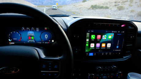 Digital dashboard and Apple CarPlay navigation in a Ford truck, possibly for an RV rental journey, driving on Blue Diamond Rd.
