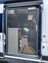 RV rental's open side door with a pleated screen, revealing an interior sink and fire extinguisher inside the camper van.