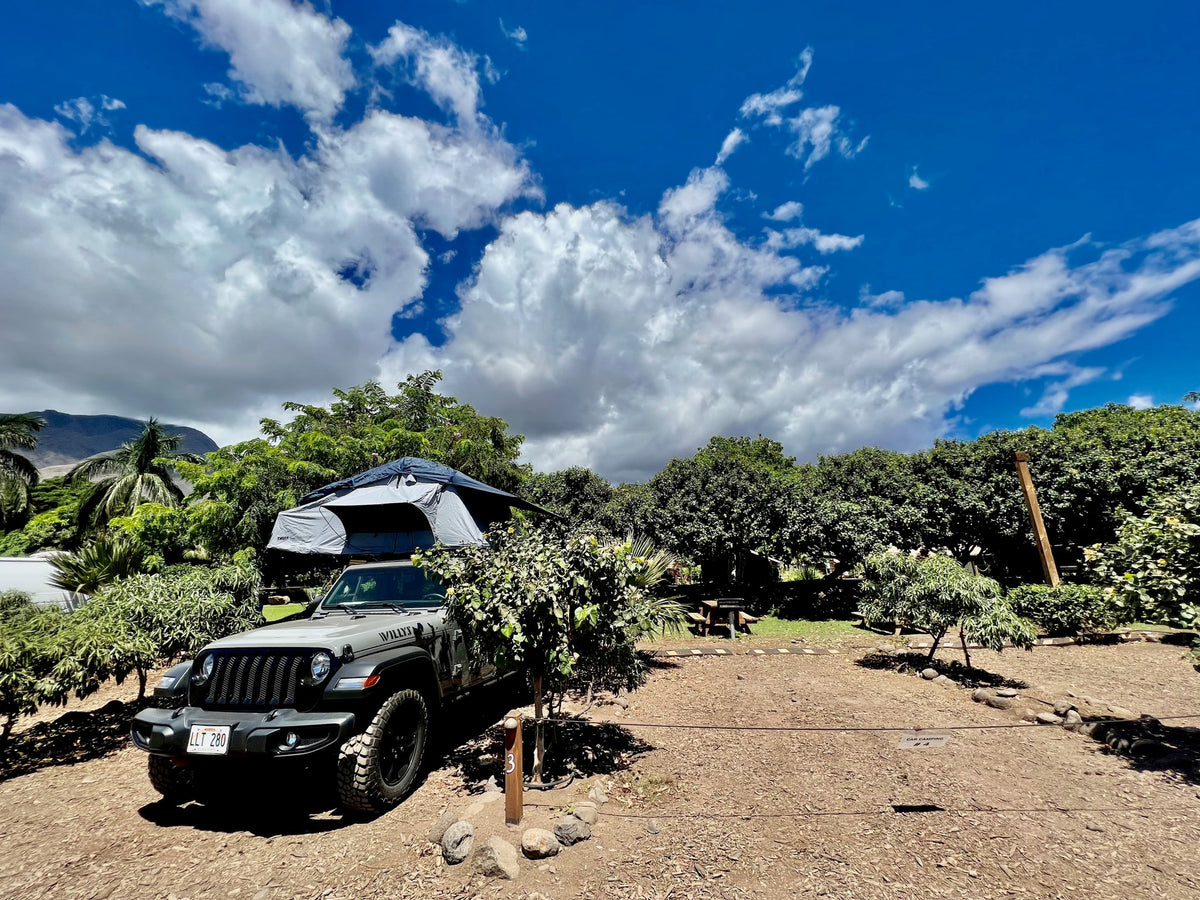 Explore with an RV rental! This Jeep with a rooftop tent is ready for camping at site #3, surrounded by lush trees. — photo 2