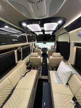 Explore this luxurious custom RV rental interior with plush seating, integrated entertainment, and modern climate control.