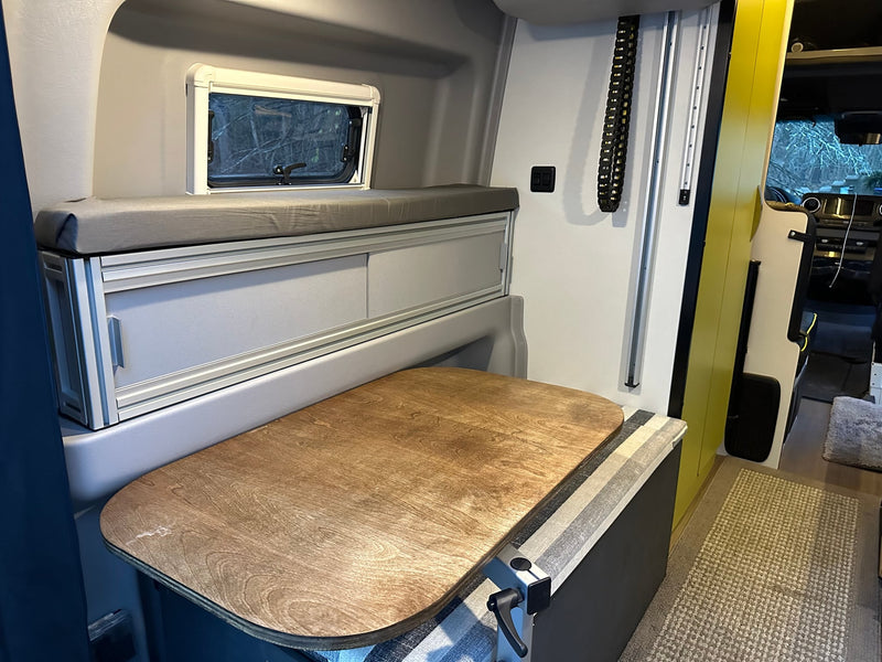  and durable flooring.|Cozy RV rental interior with striped bench seating — photo 10