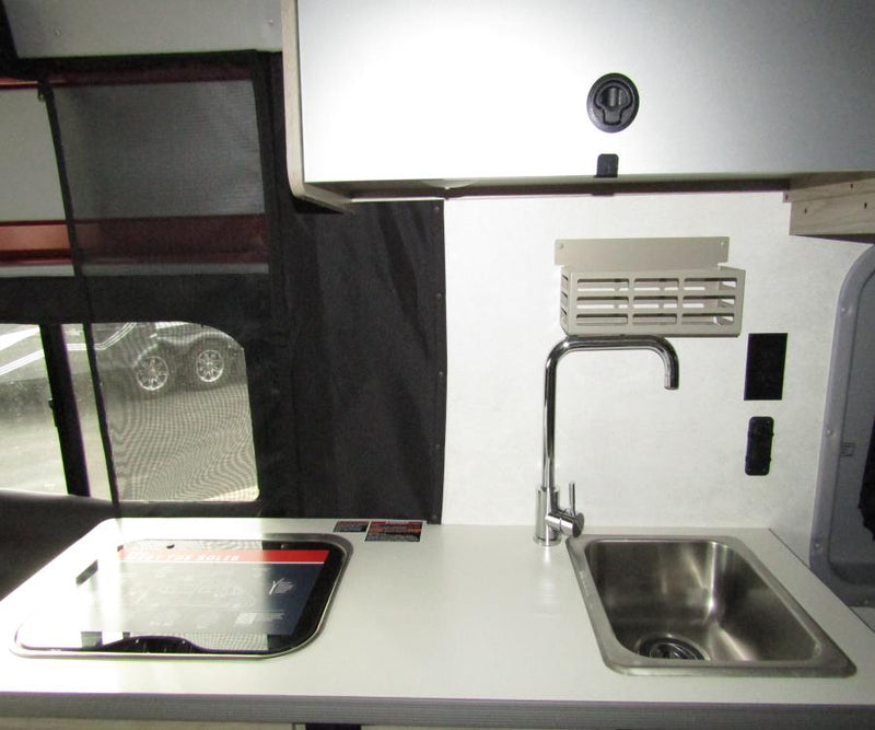  showing the interior with a fridge and child car seat.|Inside a comfortable RV rental van — photo 7