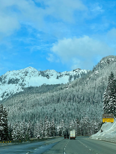 Snowy I-90 drive at Snoqualmie Pass. Mountains & forests blanketed in white; perfect for an rv rental adventure!