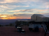 Beautiful desert sunset over a rooftop tent trailer campsite. Find your next outdoor adventure or RV rental experience!