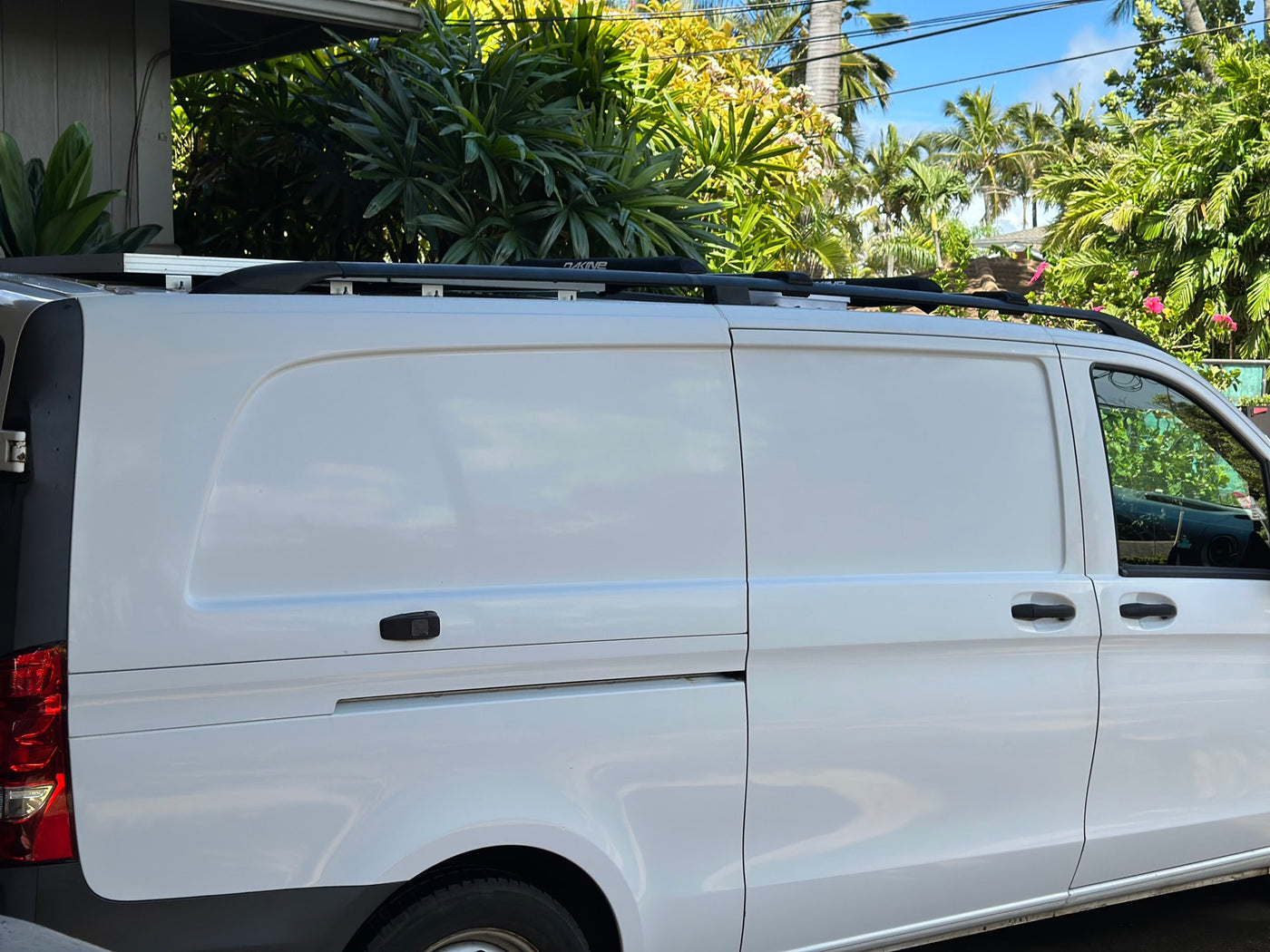 White RV rental cargo van with roof racks. Parked in a sunny tropical setting, ready for adventure. — photo 3